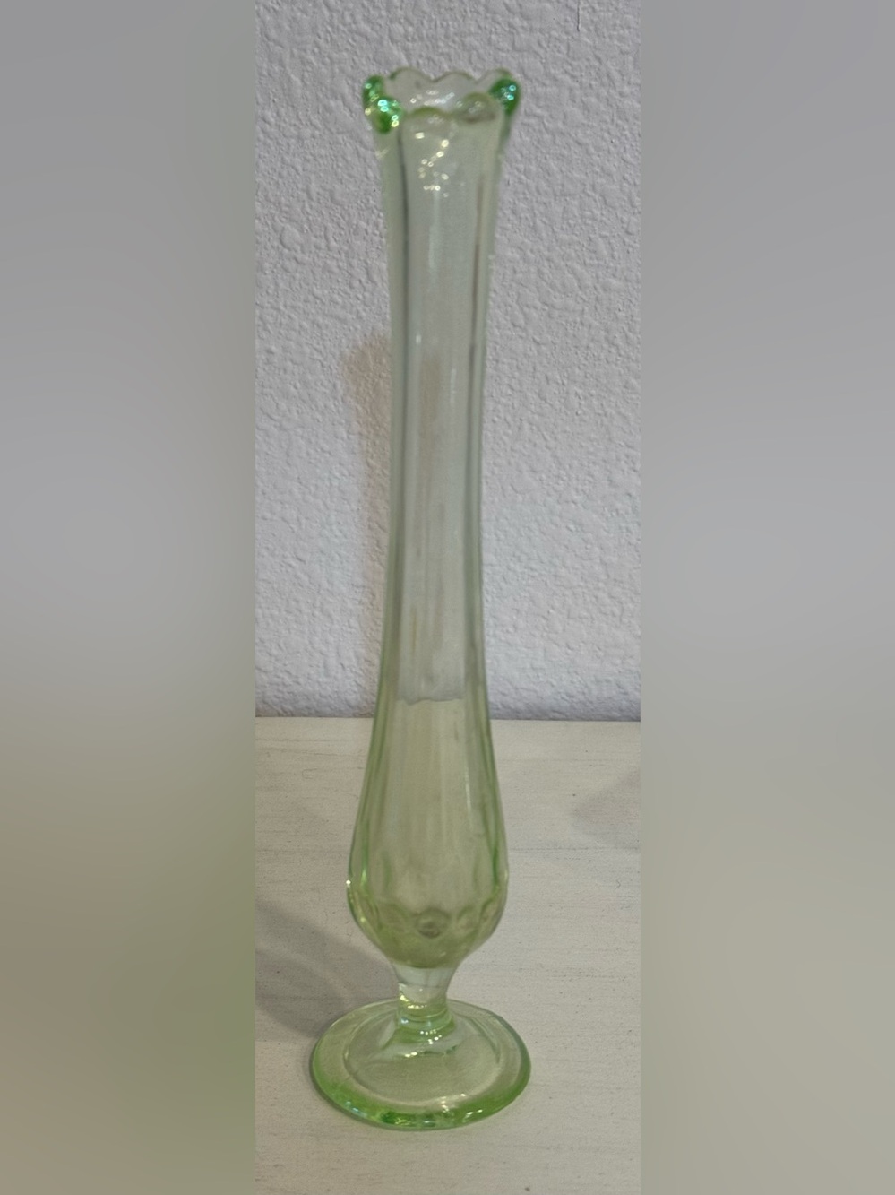 Vintage Fenton Vaseline green glass swung bud vase with a ruffled rim
